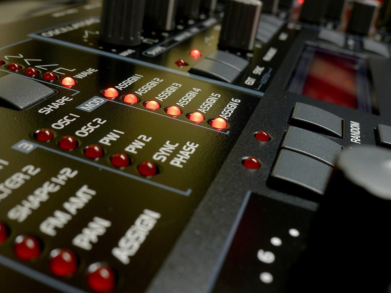 An Access Virus C desktop synthesizer in red, a DSP-based virtual analog synth now emulated by the free Osirus plugin