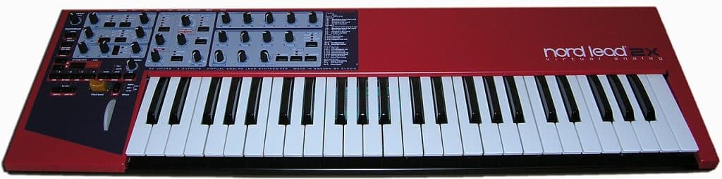 A red Clavia Nord Lead 2X virtual analog synthesizer seen from the front, with its knob panel and keyboard